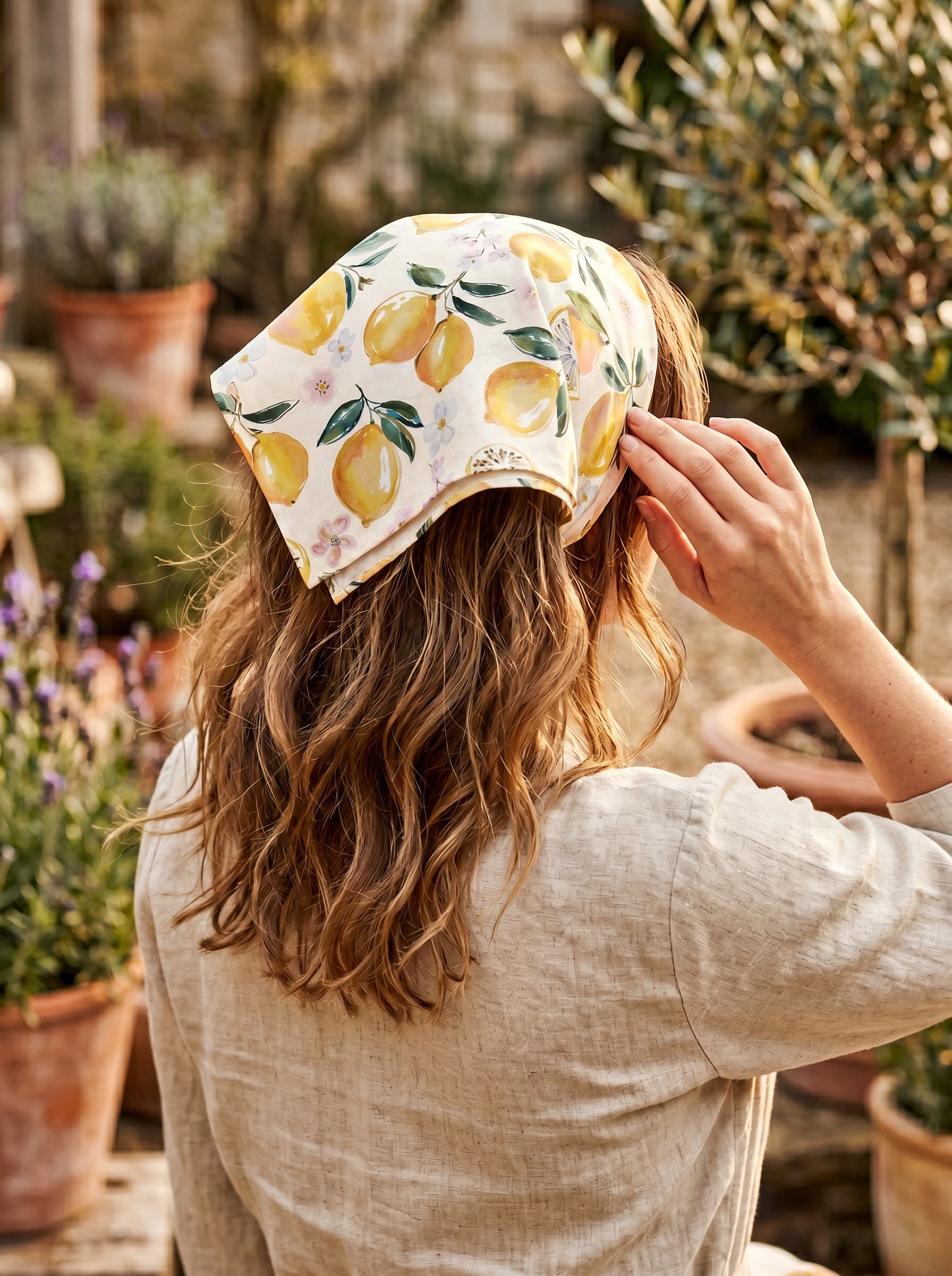 Mediterranean lemon and floral bandana styled as a women’s hair scarf outdoors&nbsp;